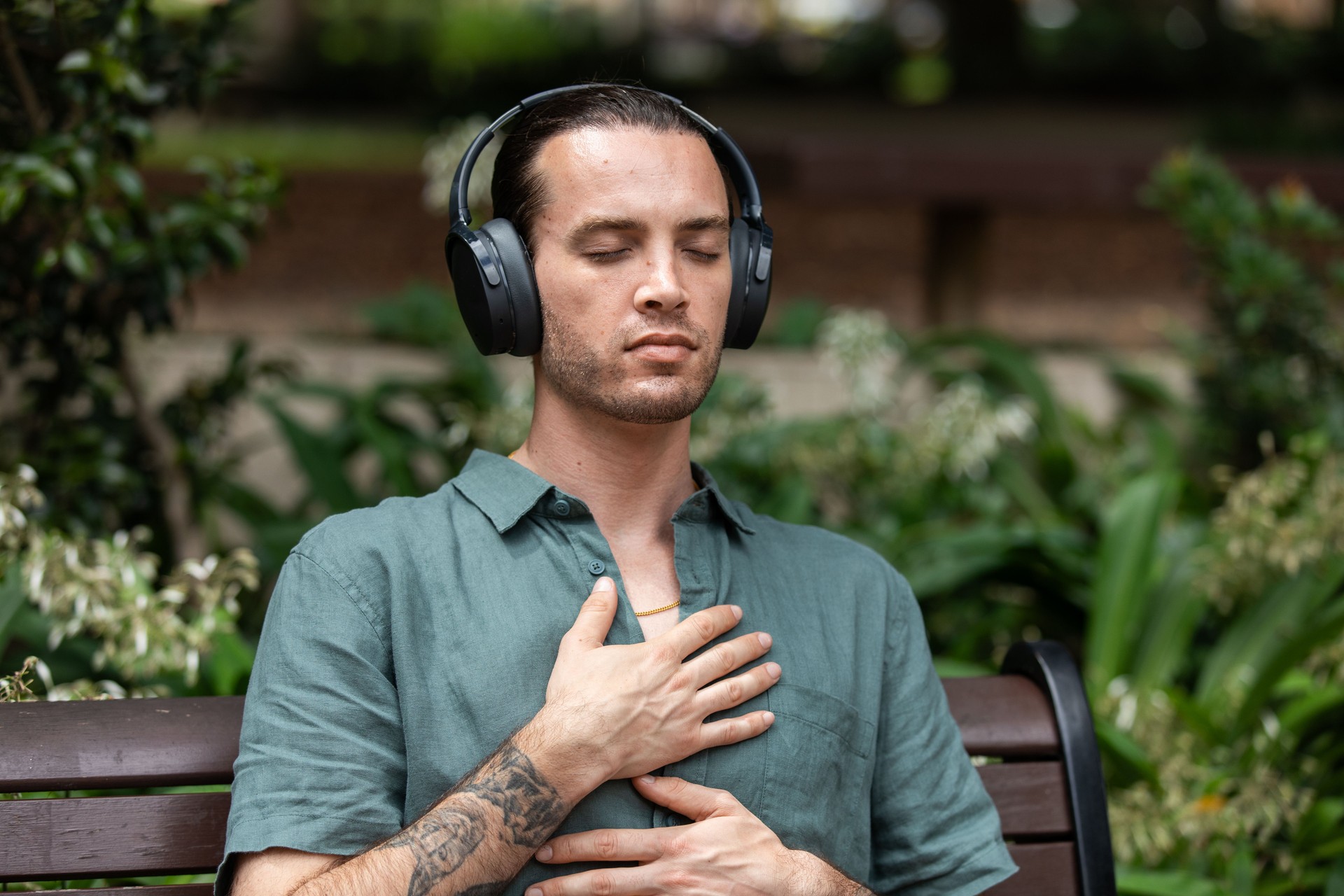 Young non-binary adult takes a mindful break in the park
